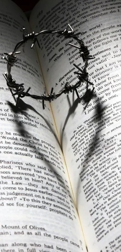 Crown of thorns casting shadow on book pages.