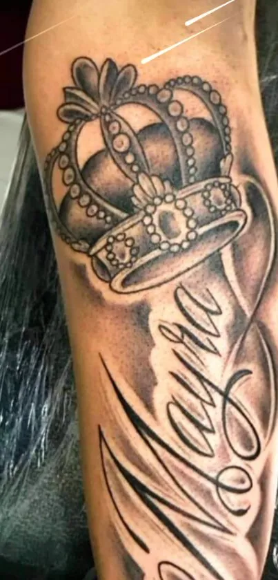 Arm tattoo with a royal crown and stylish lettering.