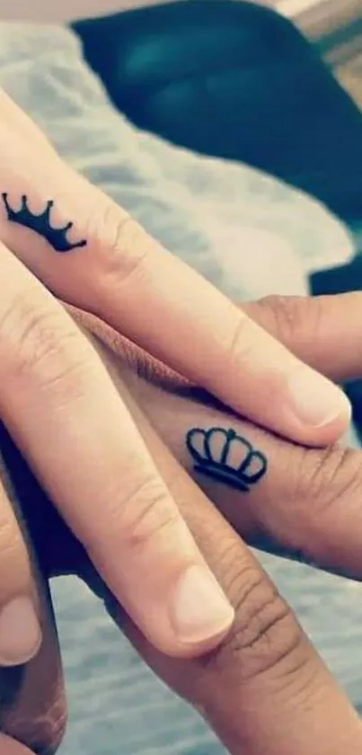 Two hands with crown tattoos, symbolizing love.