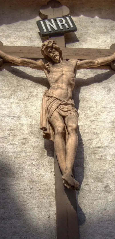 Crucifix against a stone wall mobile wallpaper.