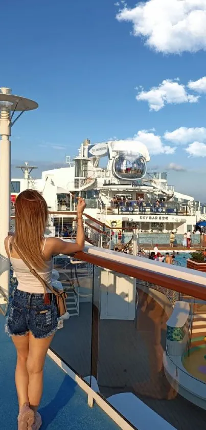 Woman on cruise ship deck under blue sky with ocean view.