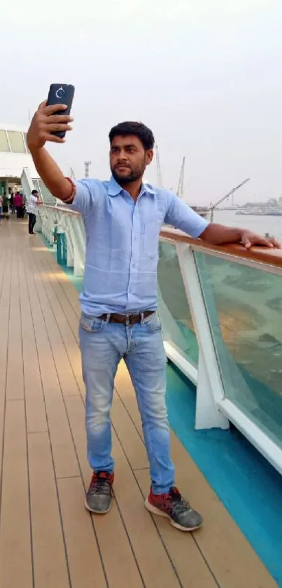 Person taking a selfie on a cruise deck featuring sea views.