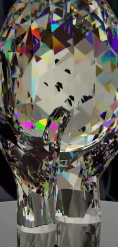 Crystal art with hand and light reflections.