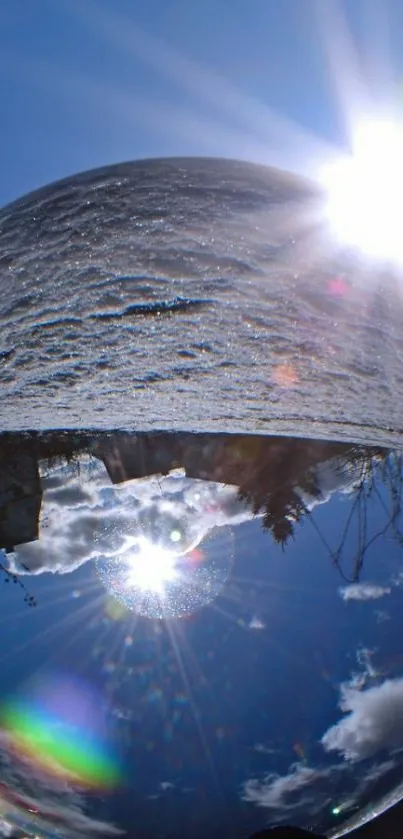 Reflective crystal sphere with bright sky and landscape.