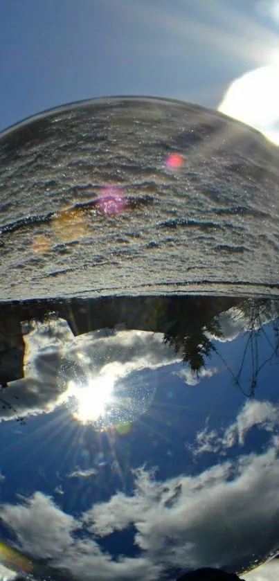 Crystal sphere under a sunlit blue sky.