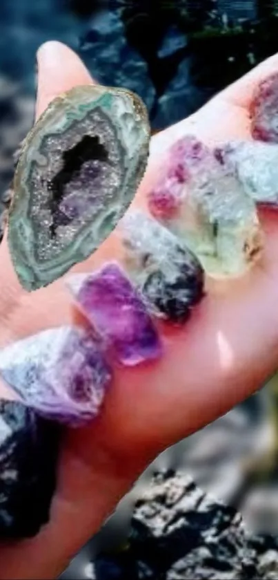 Hand holding vibrant colorful crystals in nature.