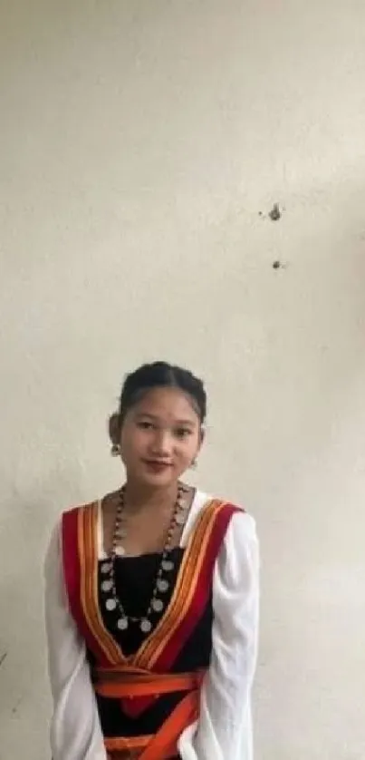 Portrait in traditional attire with a minimalist background.