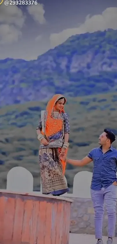 Couple in traditional clothes with mountain backdrop.