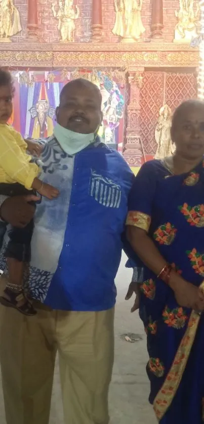 Family posing at colorful cultural festival event.