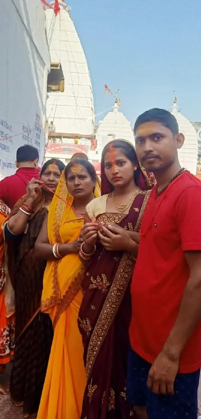 Traditional gathering at temple in vibrant attire.