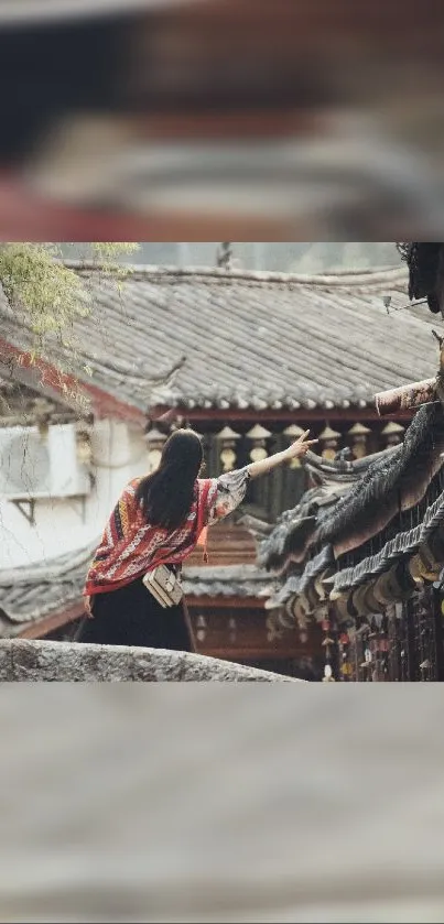 Woman admiring traditional architectural scenery on a mobile wallpaper.