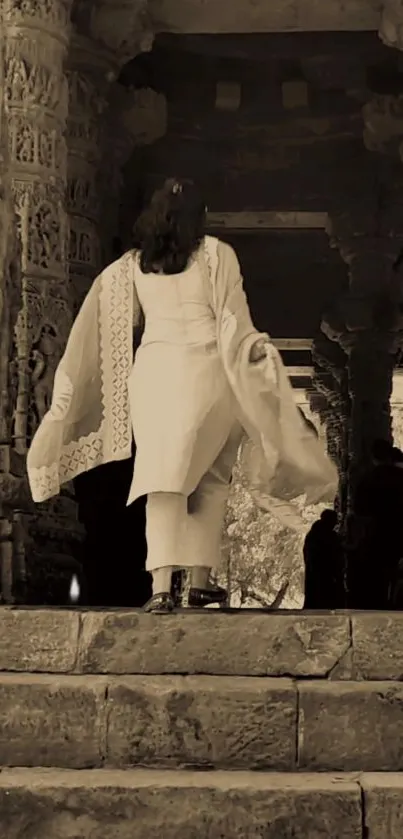 Woman in traditional dress walks through ancient stone archway.