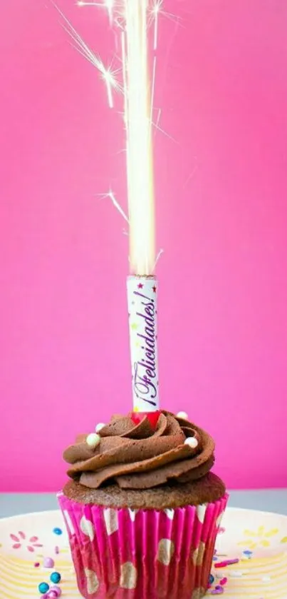 Cupcake with sparkler on pink background, vibrant and festive mobile wallpaper.