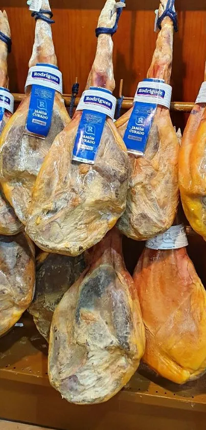 Display of hanging cured ham legs in a traditional setting.