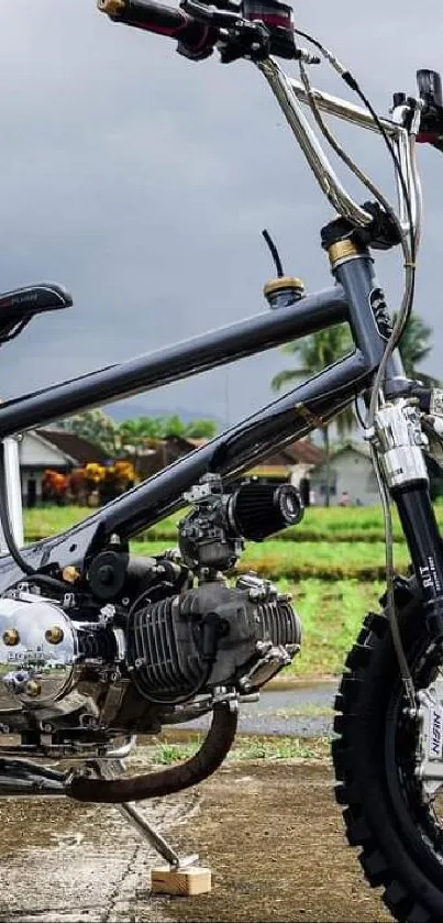 Custom mini bike on a scenic road with a cloudy sky.