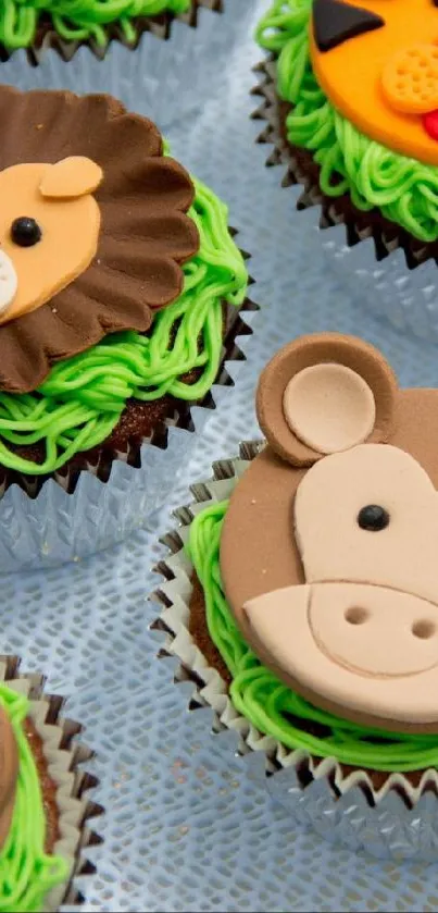 Cute cupcakes with animal faces on green icing.