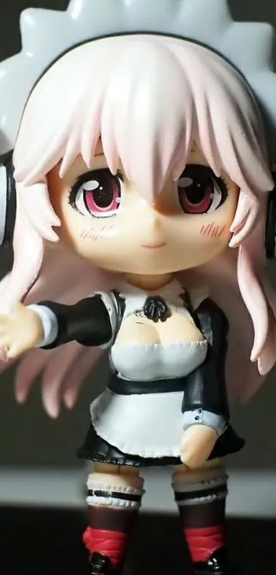 Cute anime figure in maid outfit with pink hair and headphones.