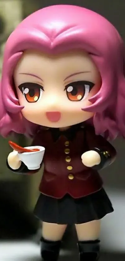 Anime figurine with pink hair holding a cup.