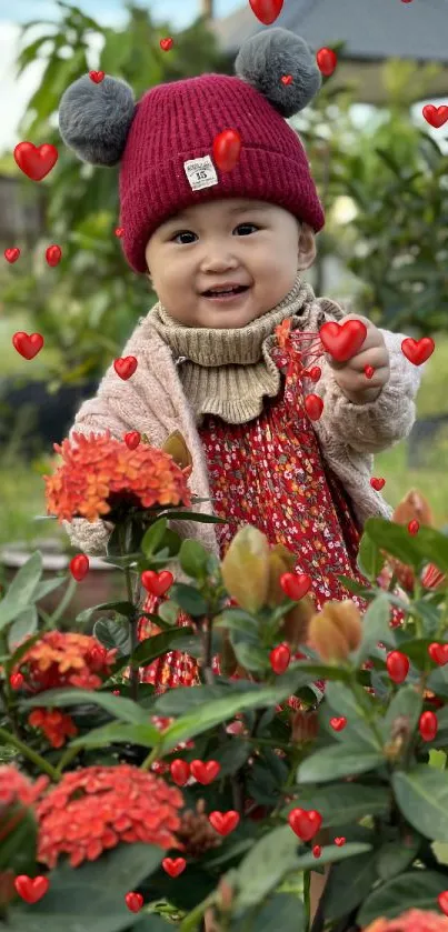 Adorable baby with red hat in a vibrant flower garden.