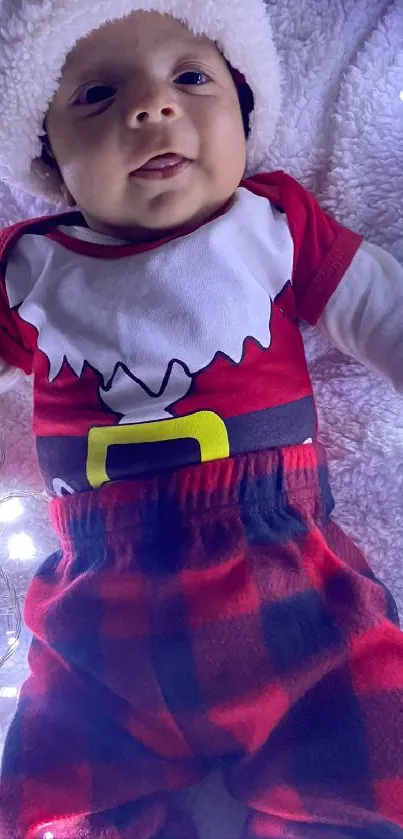 Baby dressed in a Santa outfit with festive lights.