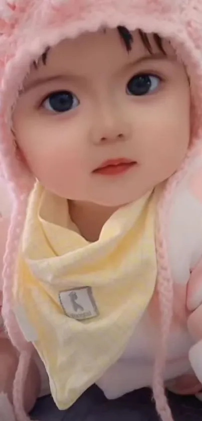 Adorable baby wearing a pink beanie and cozy outfit.