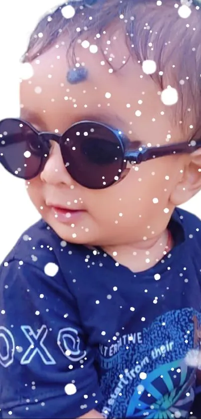 Adorable baby wearing sunglasses with snow effects, perfect for wallpapers.