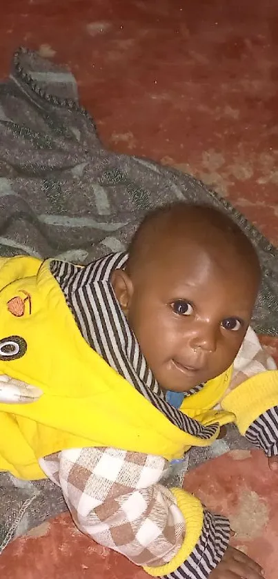 Cute baby lying on a colorful rug on the floor.