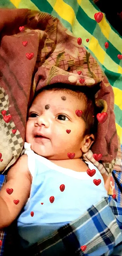 Adorable baby smiling on a colorful bed.