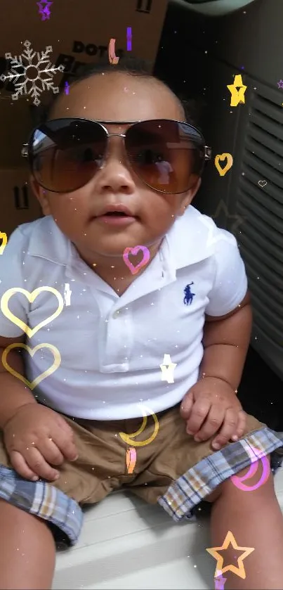 Cute baby wearing sunglasses with colorful hearts and stars around.