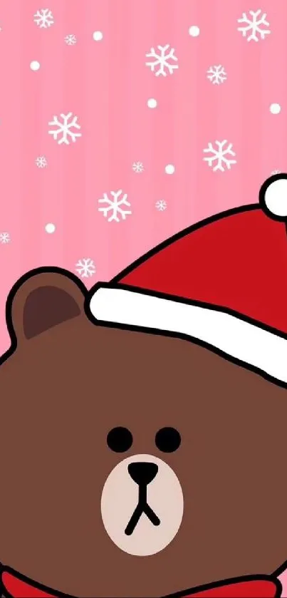 Cute brown bear with Santa hat on pink background.