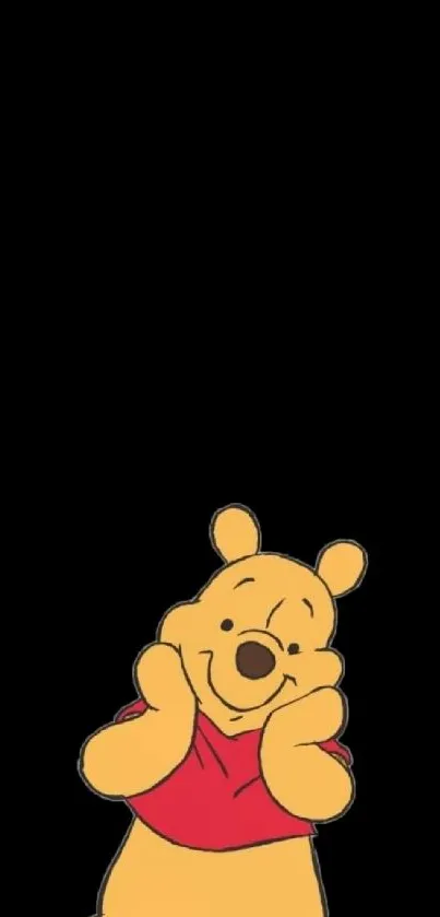 Adorable yellow bear in red shirt on black mobile wallpaper.