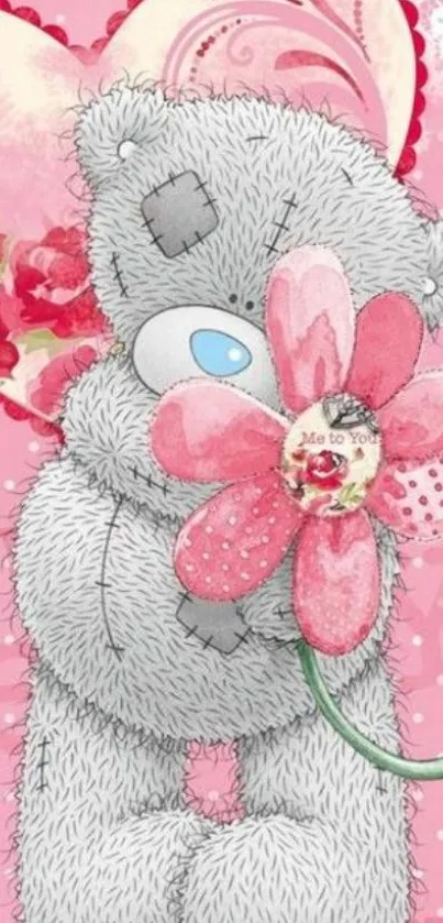 Cute teddy bear with pink flower on a pink background.