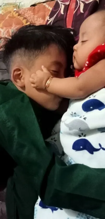 Brother and baby peacefully asleep together, wrapped in blankets.