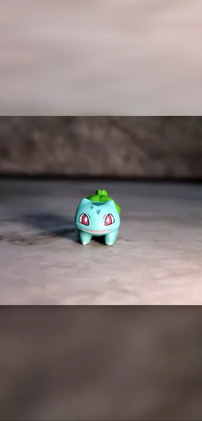 Cute Bulbasaur toy on a neutral background, perfect for mobile wallpaper.