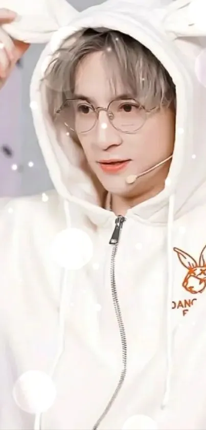 Person in a white bunny-eared hoodie and glasses.