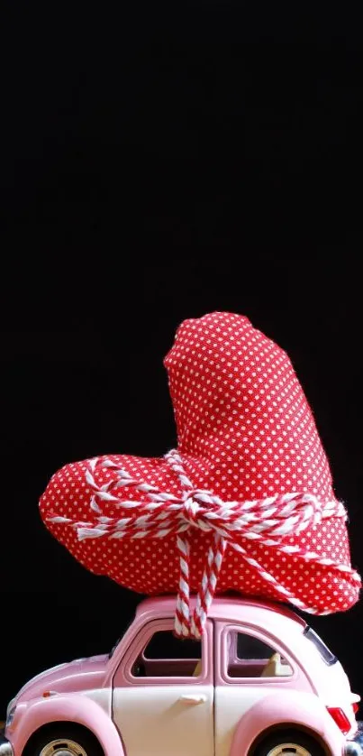 Pink toy car with polka dot gift on black background.