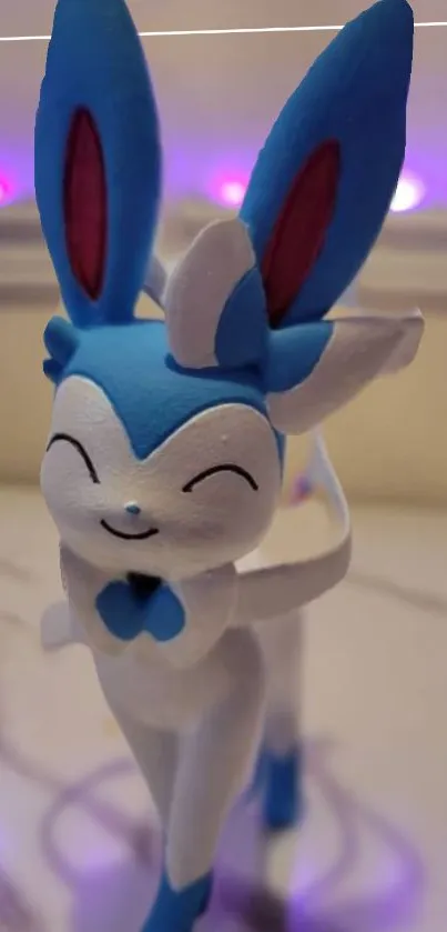 Cute cartoon figurine with blue ears and a playful smile in vibrant colors.