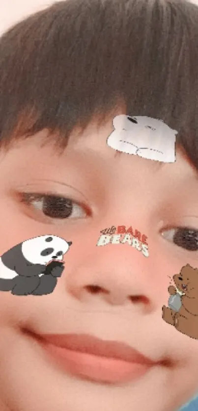 Child's face with cartoon bear stickers on forehead.