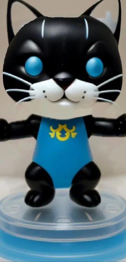 Cute cat figurine with blue eyes and suit on a toy stand.