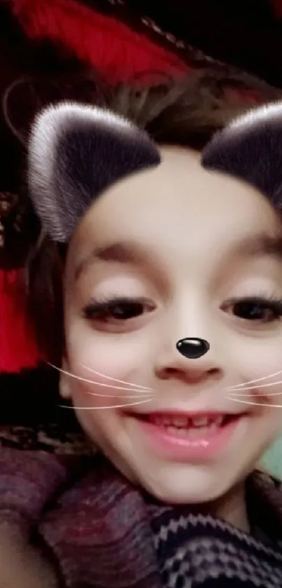 Smiling child with cat ear filter on a fun wallpaper.