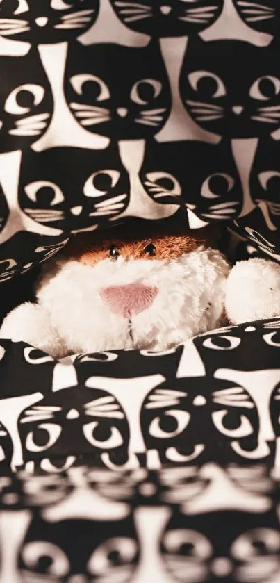 Stuffed cat in black and white cat pattern bedding.