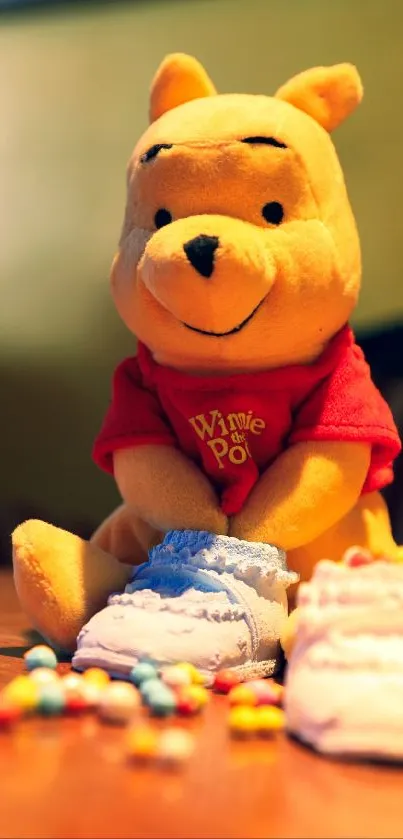 Cute plush character with colorful candies on a table.