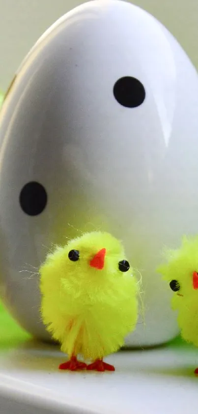 Fluffy yellow chicks next to a large polka-dotted egg.