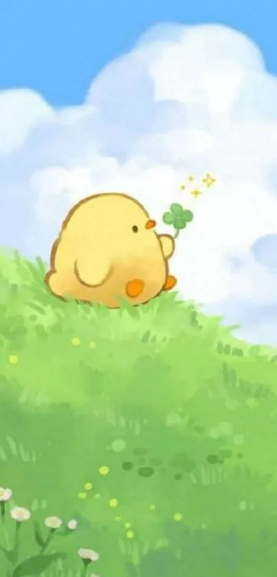 Cute yellow chick on a green hill under a blue sky.