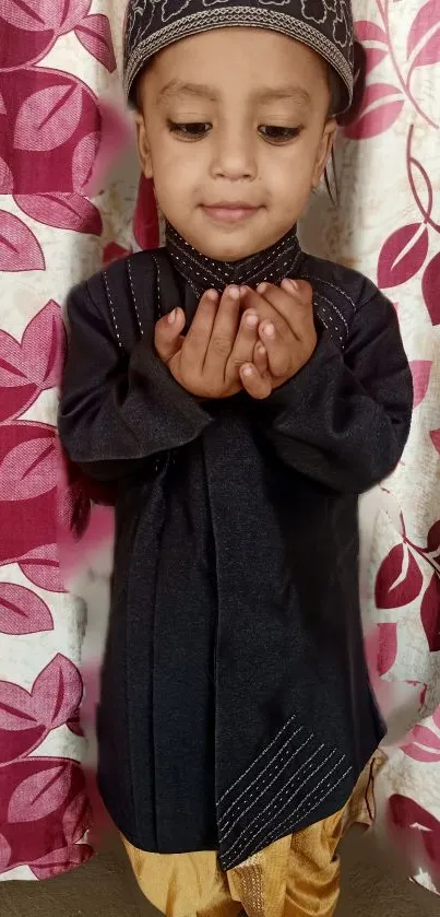 Child in traditional attire with a patterned background.