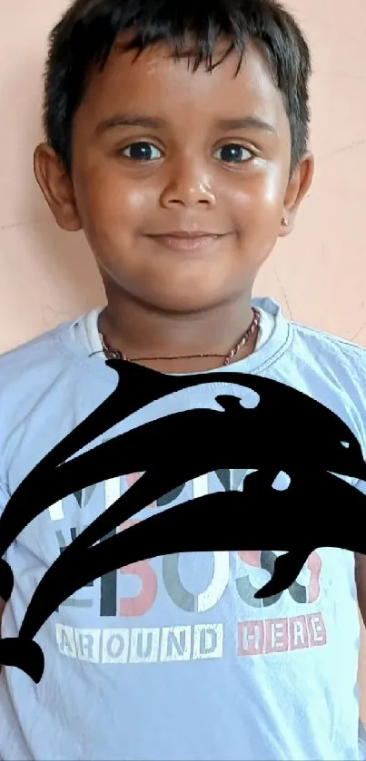 Smiling child wearing blue shirt, with dolphin overlay.