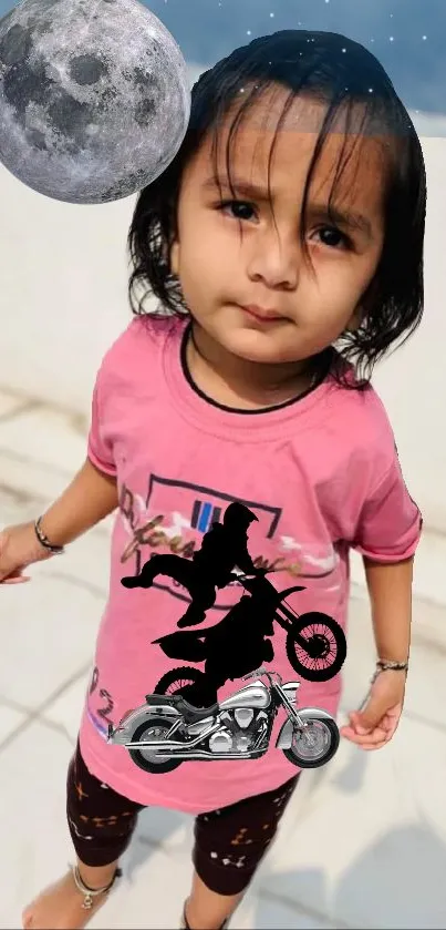 A cute child in a pink shirt with motorcycle graphic and moon above.