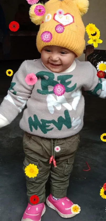 Smiling baby in winter clothing with a yellow beanie.