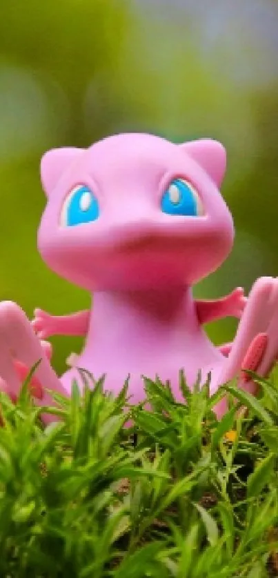 Pink creature with blue eyes on green grass background.