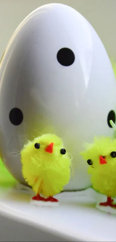 Bright yellow chicks with a white polka-dotted egg in a festive scene.